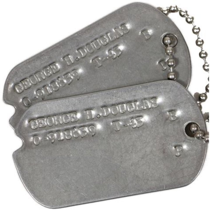 The officer had dog tags and what appeared to be a bullet casing around his neck. His mother is believed to be beside him, followed by his wife